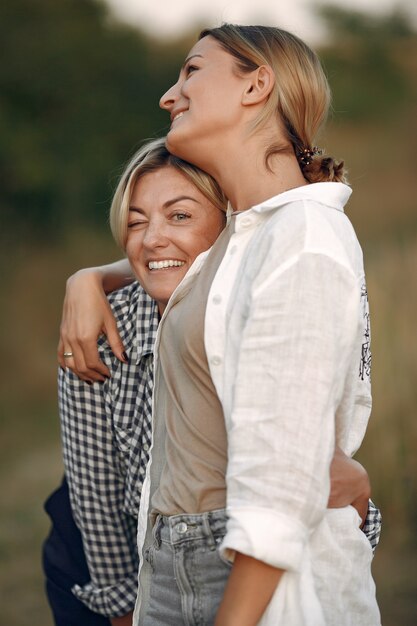 Beautiful elegant women in a autumn wheat field