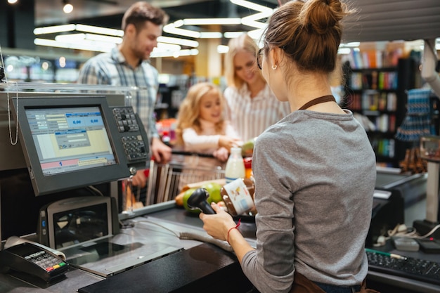 Beautiful family standing at the cash counter