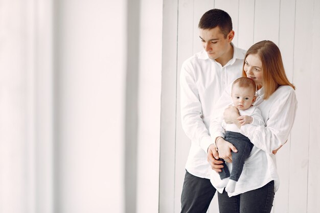 Beautiful family standing on white