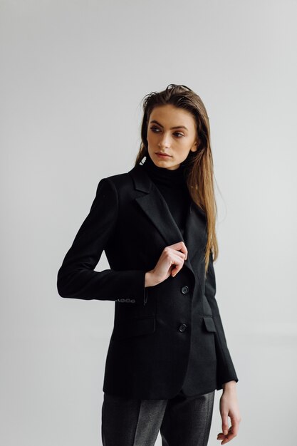 Beautiful fashion woman posing with elegant suit