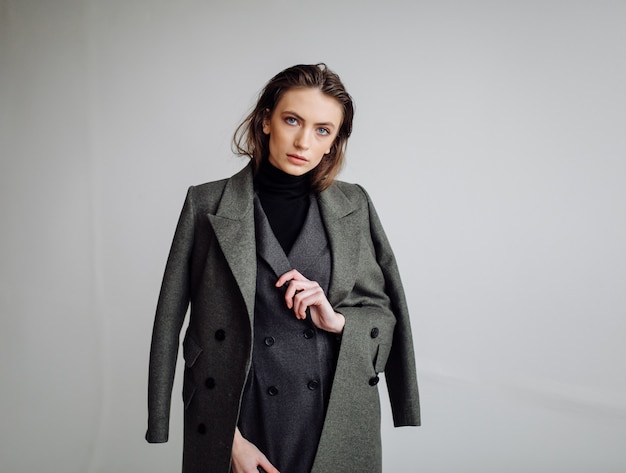 Beautiful fashion woman posing with elegant suit