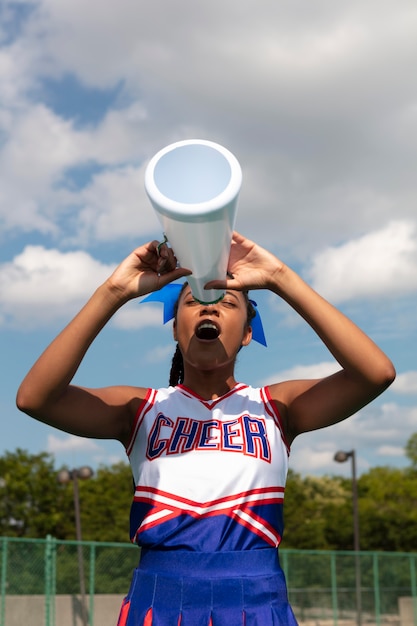 Beautiful female cheerleader in cute uniform