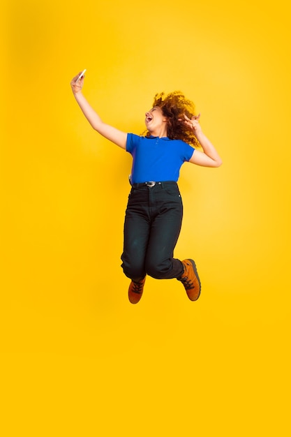 Beautiful female curly model jumping