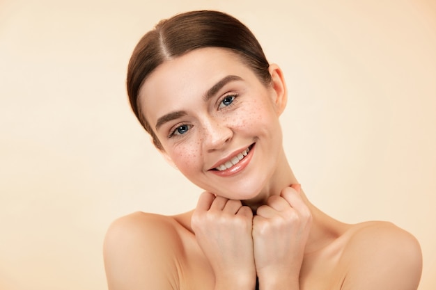 Free Photo a beautiful female face. perfect and clean skin of young caucasian woman on pastel studio background.