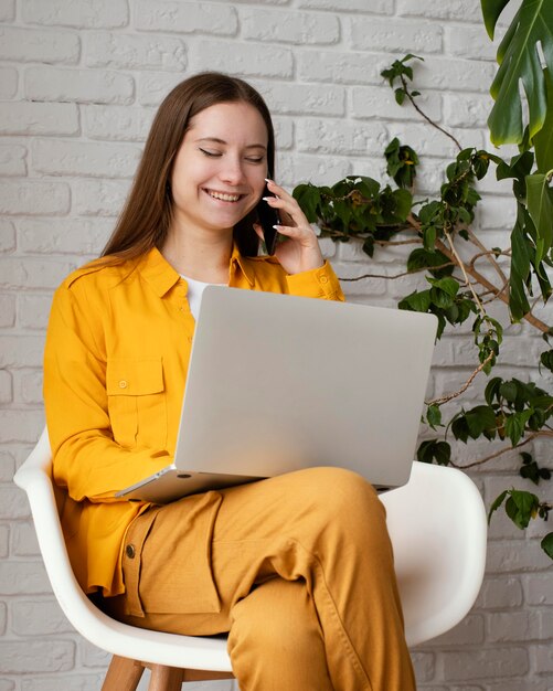 Beautiful female gardener working on her laptop