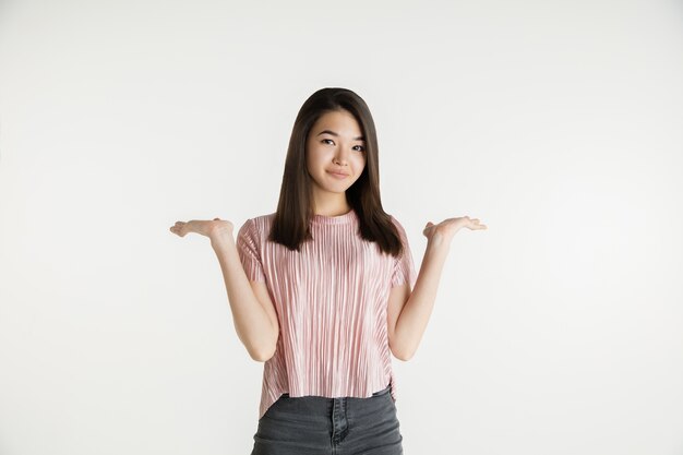 Beautiful female half-length portrait isolated on white  space. Young emotional woman in casual clothes