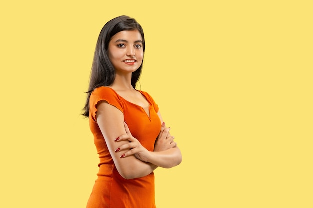 Free photo beautiful female half-length portrait isolated. young emotional indian woman in dress standing crossing hands. negative space. facial expression, human emotions concept.