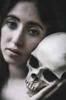 Free photo beautiful female with human skull