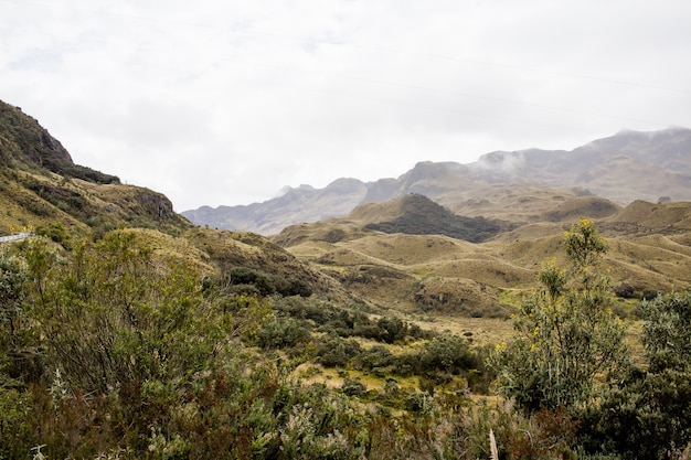 Free photo beautiful field with amazing rocky mountains and hills and amazing cloudy sky