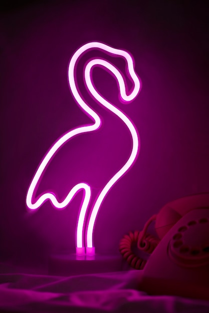 Free photo beautiful flamingo neon sign in bedroom