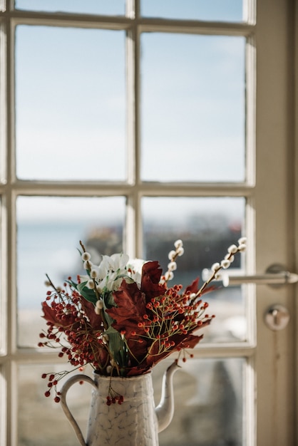 Free photo beautiful flower composition in a flowerpot by the window