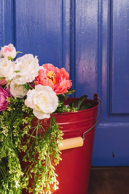 Free photo beautiful flowers in bucket