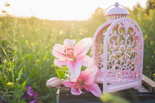 Free Photo beautiful flowers next to a decorative lantern