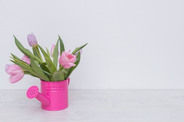 Beautiful flowers in watering pot