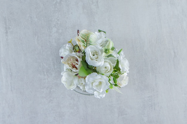 Beautiful fragrance flowers and glass, on the white table.