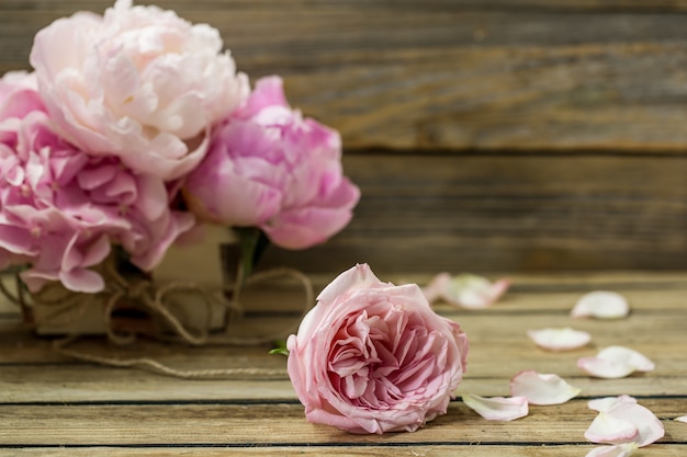 Free photo beautiful fresh flowers on wooden background, various flowers, place for text, closeup