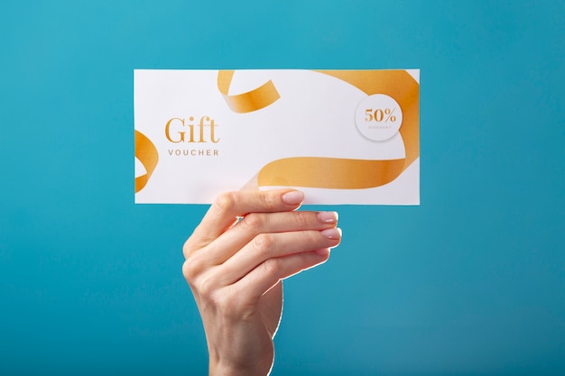 Free photo beautiful gift voucher with hand