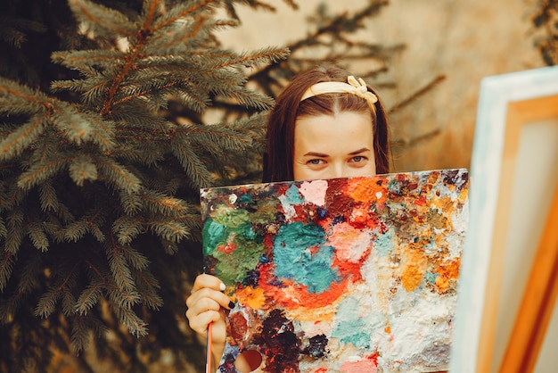 Free photo beautiful girl drawing in a field