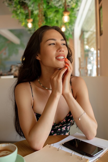 Beautiful girl drinking coffee in a cafe