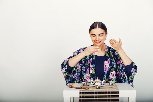 Free Photo beautiful girl drinking a tea in a studio