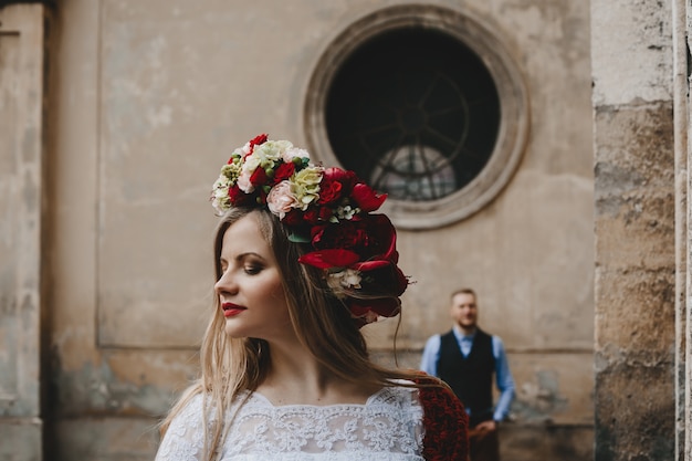 The beautiful girl has a wreath with flowers