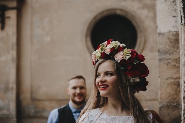 The beautiful girl has a wreath with flowers