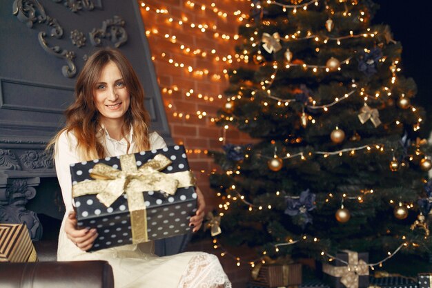 Beautiful girl at home near christmas tree