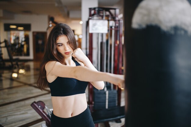 A beautiful girl is engaged in a gym