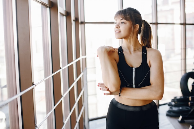 A beautiful girl is engaged in a gym