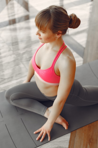 A beautiful girl is engaged in a gym