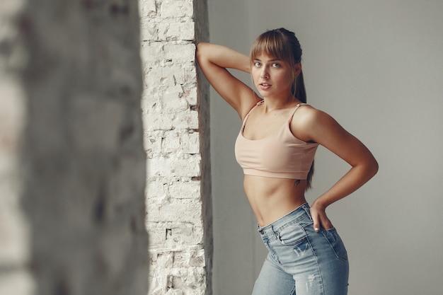 A beautiful girl is engaged in a yoga studio