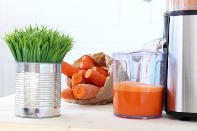 Free photo beautiful girl making carrot juice