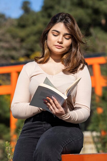 A beautiful girl reading book at the park High quality photo