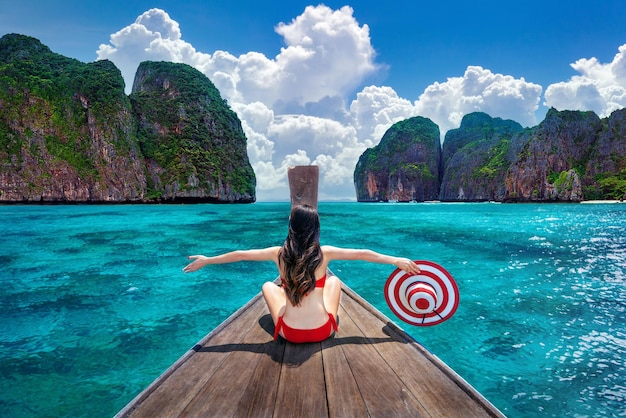 Free photo beautiful girl in red bikini on boat at koh phi phi island thailand