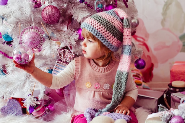 The beautiful girl  sitting near Christmas Tree