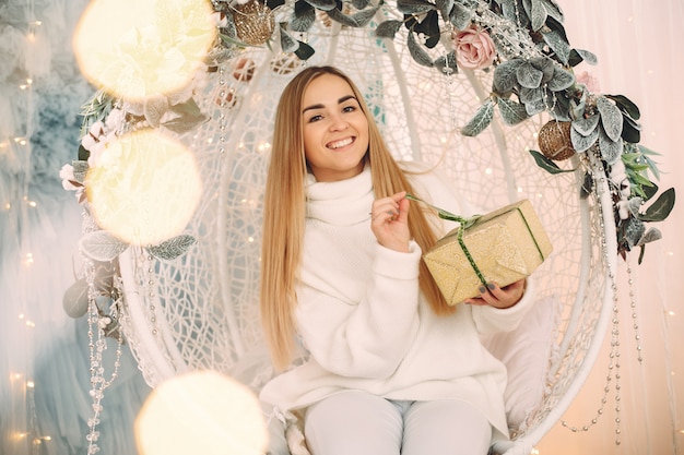 Free photo beautiful girl sitting in a studio with presents