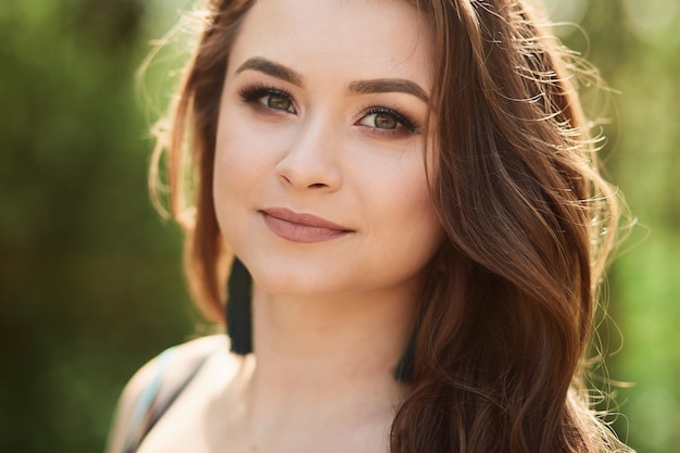 The beautiful girl stands in the park