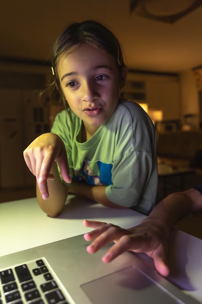 Free photo beautiful girl studies at the computer at night technology and education