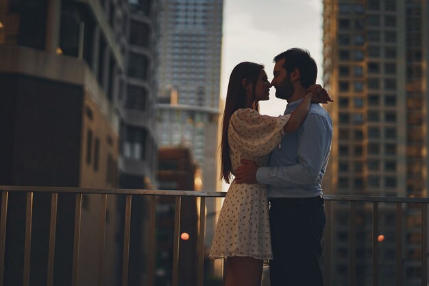 beautiful girl in summer dress with her handsome husband in white shirt and pants 