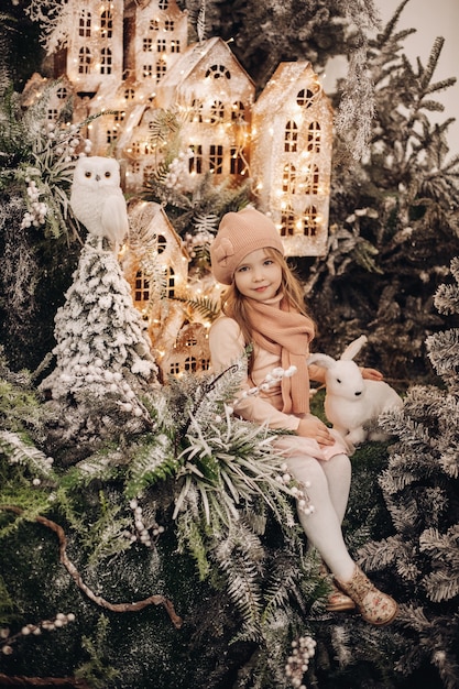 Free photo beautiful girl takes photos in a christmas decoration with a lot of trees under a snow and lights