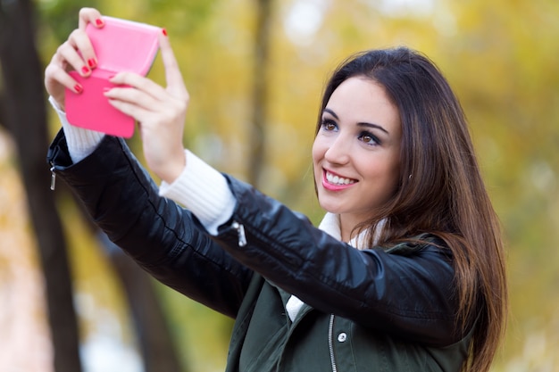 Free Photo beautiful girl taking a selfie in autumn.