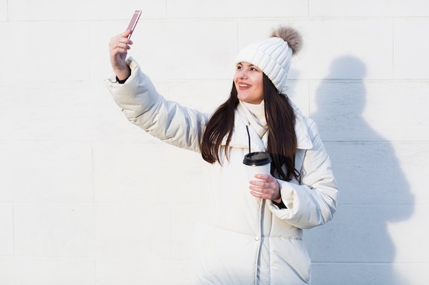 Free Photo beautiful girl taking selfie in outwear