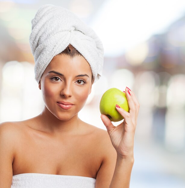 Beautiful girl in towel with healthy apple