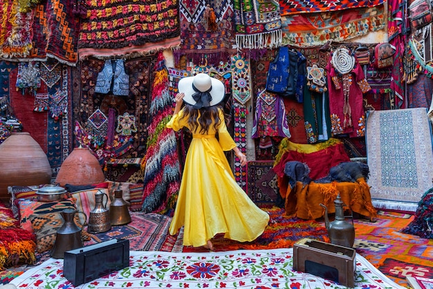 Beautiful girl at traditional carpet shop in Goreme city, Cappadocia in Turkey.