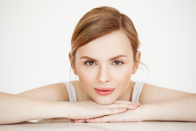 Free photo beautiful girl with perfect clean skin smiling sitting at table . beauty spa and cosmetology.