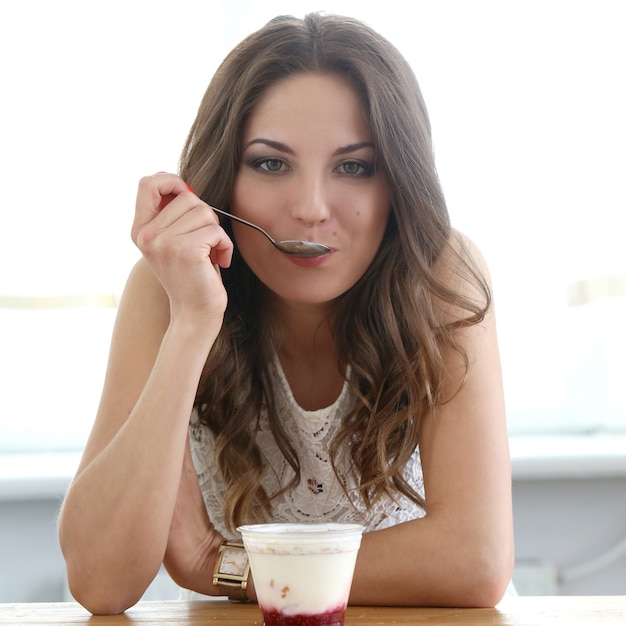 Beautiful girl with yoghurt