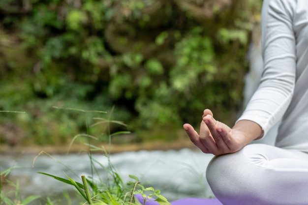 Beautiful girls are playing yoga at the park