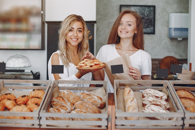 Free photo beautiful girls buys buns at the bakery