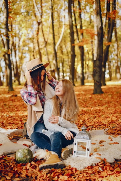 Beautiful girls have fun in a autumn park