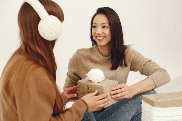 Beautiful girls have fun in a studio with presents